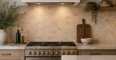 Kitchen backsplash with travertine tile in a modern kitchen featuring warm neutral tones and natural stone texture