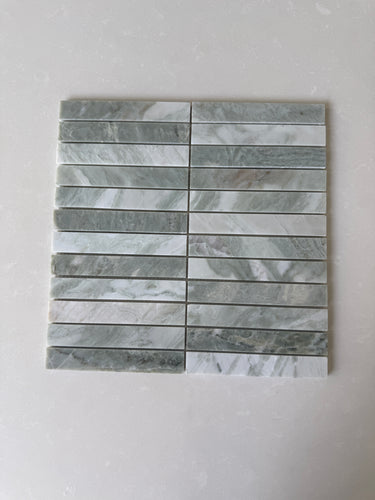 White Mix 11x11 Roca natural stone pebble mosaic tile for wall installation, showing textured white pebble pattern.