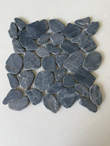 Black 11x11 natural stone pebble mosaic tile for wall installation by Roca, showing textured pebble surface and mosaic pattern.