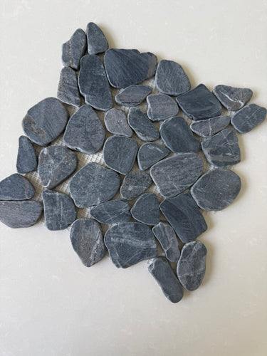 Black 11x11 natural stone pebble mosaic tile for wall installation by Roca, showcasing textured pebble pattern and earthy tones.