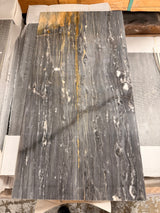Polished Bardiglio Ciello 12x24 natural stone marble tile by RN, showing sleek gray and white veined surface for flooring or wall use.