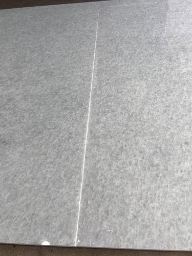 Polar white polished natural stone tile from RN, 24x48 inches, showcasing a smooth, glossy surface with subtle veining.