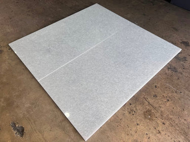 Polar White 24x48 polished natural stone tile from RN, showcasing a smooth, glossy surface with a subtle white marble pattern.