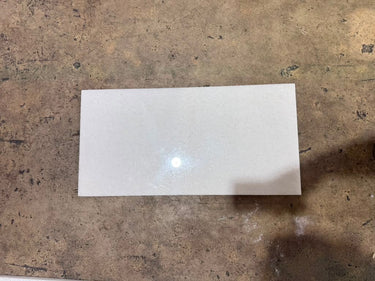 Polar White 12x24 polished natural stone tile by RN, showcasing smooth, glossy white surface with subtle veining and polished finish.