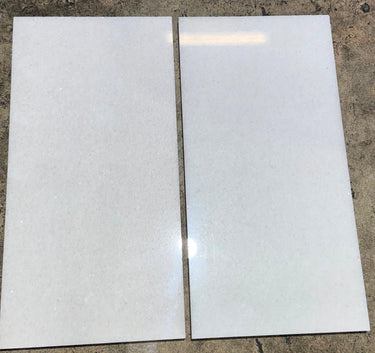 Polar White 12x24 polished natural stone tile by RN, showcasing smooth, glossy surface and modern rectangular design.