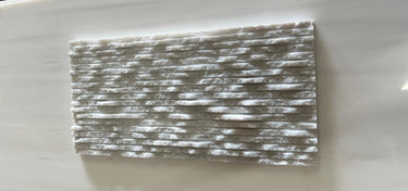 Ice White 6x12 3D split face marble tile by RN, showcasing natural stone with textured, geometric 3D surface in white tones.