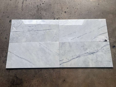 Lailak Marble 12x24 polished natural stone tile from RN showing smooth, glossy marble surface with gray and white veining.