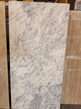 Arabescato marble 24x48 leather finish natural stone tile with elegant veining, ideal for sophisticated interior surfaces.