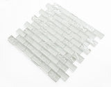 Crystal Aqua Soho White 1x2 glass mosaic tile installed on a bathroom shower wall with clean white tones and reflective glass surfaces.