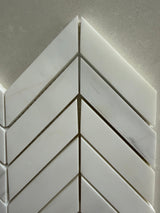 White marble chevron mosaic tile used on a luxury shower wall installation
