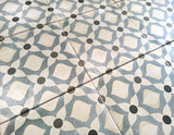 European-inspired decorative porcelain tile floor featuring intricate blue and white motifs