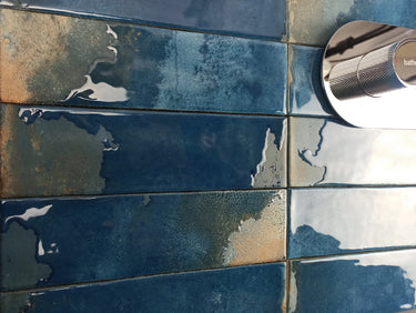 Glossy blue porcelain tile installed as a kitchen backsplash