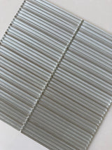 Roca Lux Sand 12x12 flutted glass mosaic tile for wall installation, featuring textured, sandy-colored glass surface.