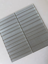 Roca Lux Sand 12x12 fluted glass mosaic wall tile, showcasing a textured, sandy-toned backsplash with a modern design.