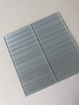 Roca Lux Smoke 12x12 Flutted Glass Mosaic Wall Tile showing smoky gray, textured glass tiles for backsplash or wall decor.