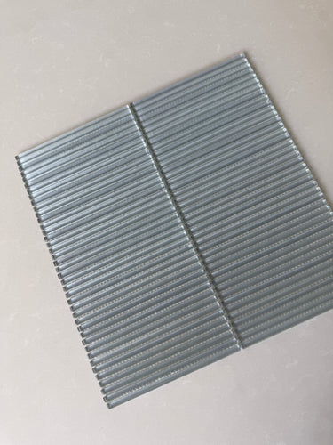 Roca Lux Smoke 12x12 Flutted Glass Mosaic Wall Tile showing smoky gray, textured glass tiles for backsplash or wall decor.
