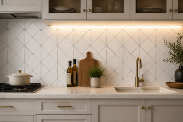 Mona Dolomite mosaic tile with blue dot pattern from Mythology Tile, polished marble backsplash featuring a decorative geometric design.