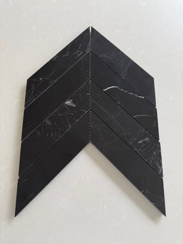 Nero Marquina polished 2x8 chevron marble mosaic tile with bold black stone and white veining