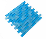 Pool-rated Crystal Aqua Osaka Sky Blue 1x2 glass mosaic tile installed on a luxury swimming pool waterline with bright blue color variation.