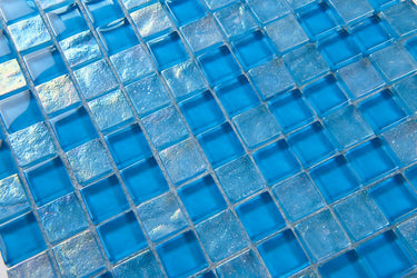 Crystal Aqua Osaka Sky Blue 1x1 glass mosaic tile used as a kitchen backsplash featuring a classic mosaic pattern and vibrant blue tones.