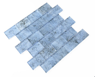 Pool-rated Crystal Aqua Sofia 2x3 glass mosaic tile installed on a luxury swimming pool waterline with reflective glass surfaces.