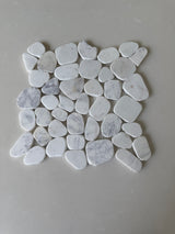 White Mix 11x11 natural stone pebble mosaic tile by Roca, showing a detailed view of textured white and beige stone pebbles for bathroom decor.