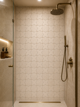 White Thales Limra honed marble mosaic tile by Mythology Tile, showing a close-up of the textured, smooth surface for shower flooring.