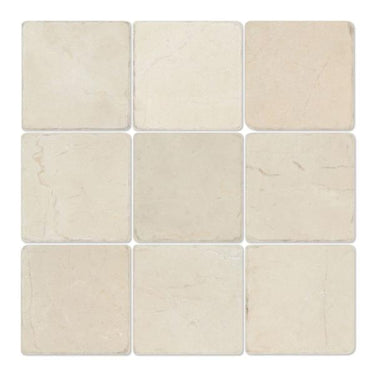 Four 4x4 tumbled Crema Marfil marble tiles, natural stone surface with warm beige tones, from MosaicBros.com