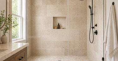 Travertine shower walls with large format tiles and glass enclosure in a modern bathroom