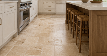 Travertine tile kitchen floor in a bright modern kitchen showing natural stone texture and warm tones
