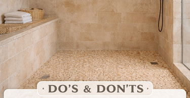 Walk-in shower with tumbled travertine mosaic floor and honed travertine wall tiles