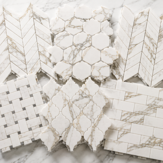 Premium Calacatta marble mosaic tile collection featuring herringbone, hexagon, chevron, basketweave, penny round, and arabesque patterns for kitchens, bathrooms, showers, and backsplashes.
