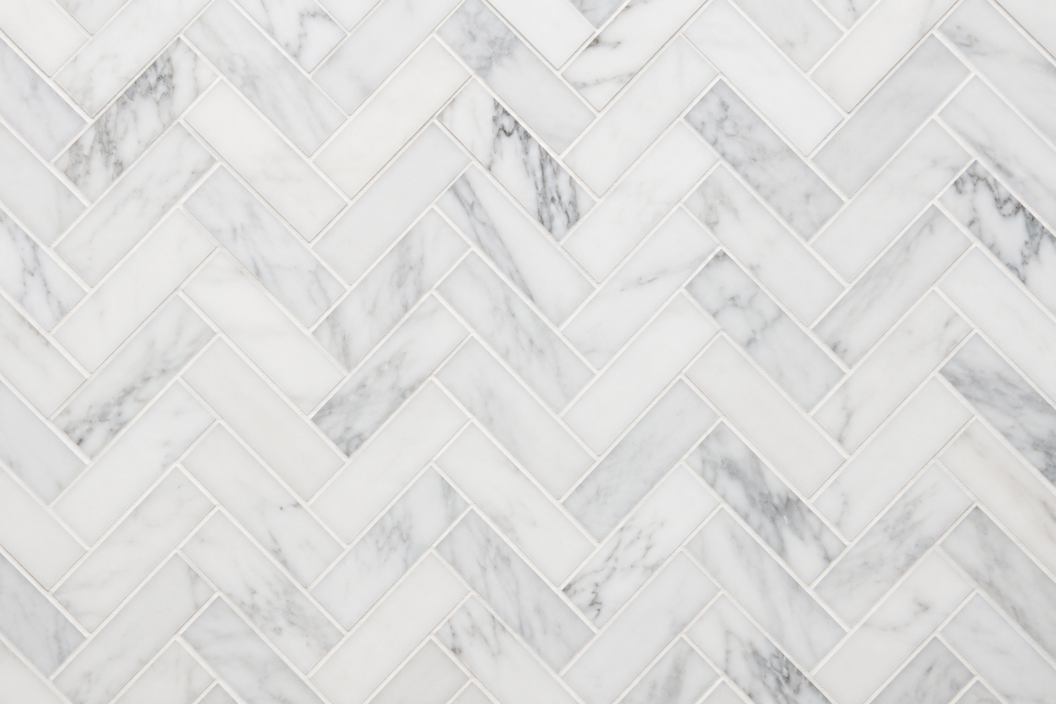 Herringbone marble tiles in Carrara Calacatta and Thassos for kitchen backsplash bathroom walls and shower design