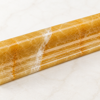 Premium Honey Onyx molding featuring rich golden tones and elegant natural veining for backsplashes, bathrooms, showers, fireplaces, and decorative wall installations.