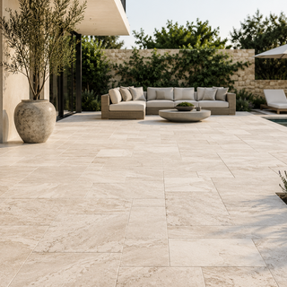 Premium natural stone and porcelain outdoor pavers installed on a modern patio with elegant landscaping and seamless indoor-outdoor living.