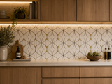 Waterjet Monaco Thassos brass and stainless steel mosaic tile by Mythology Tile, showing intricate mosaic pattern with shiny brass and steel accents.