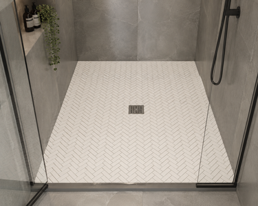 Thassos herringbone marble mosaic tile by Mythology Tile, showcasing white marble tiles arranged in a herringbone pattern.