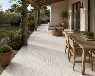 Thassos herringbone marble mosaic tile by Mythology Tile, showcasing white marble pieces arranged in a classic herringbone pattern.