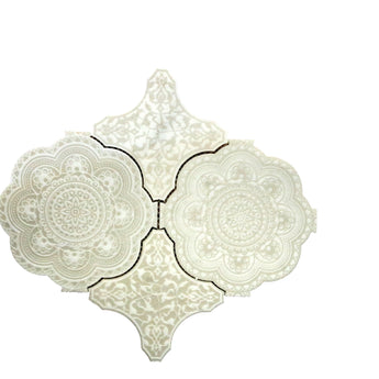 White marble waterjet mosaic tile from Mythology Tile featuring intricate Marakkesh pattern and polished surface.