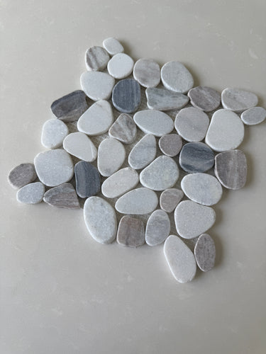 Natural stone pebble mosaic tile by Roca featuring small, smooth, multicolored stones arranged in an 11x11 grid.