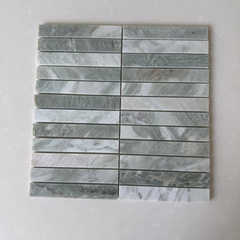 White Mix 11x11 Roca natural stone pebble mosaic tile for wall installation, showing textured white pebble pattern.