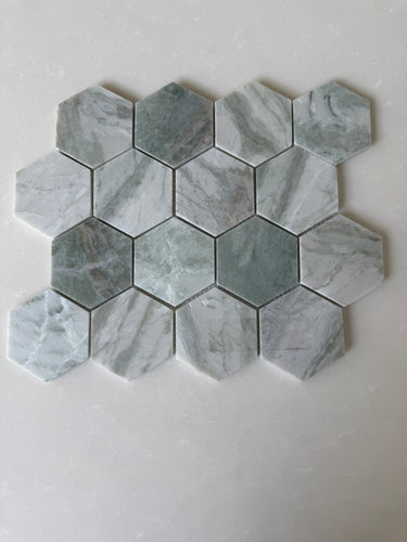 Green marble hexagon mosaic tile by Roca, natural stone with 12x12 inch geometric pattern, showcasing polished surface and intricate veining.