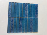 Roca Sapphire 12x12 stacked mosaic wall tile with blue and iridescent glass finish, arranged in a modern geometric pattern.