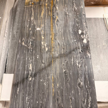 Polished Bardiglio Ciello 12x24 natural stone marble tile by RN, showing sleek gray and white veined surface for flooring or wall use.