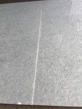 Polar white polished natural stone tile from RN, 24x48 inches, showcasing a smooth, glossy surface with subtle veining.