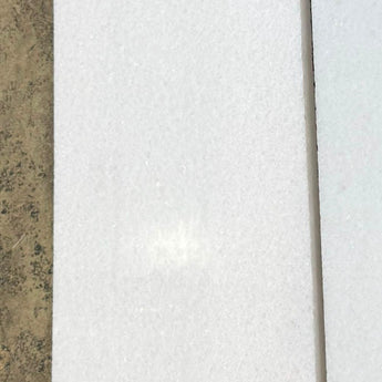 Polar white 12x24 polished natural stone tile from RN, showcasing smooth, glossy surface and modern rectangular shape.