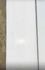 Polar white 12x24 polished natural stone tile from RN, showcasing smooth, glossy surface and modern rectangular shape.