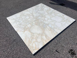 Calacatta Gold Giorgio 18x18 polished natural stone tile with white and gold veining, branded RN, showing a close-up of the surface texture.
