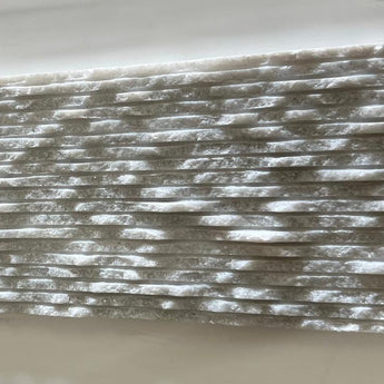 Ice White 6x12 3D split face marble tile by RN, showcasing natural stone with textured, geometric 3D surface in white tones.