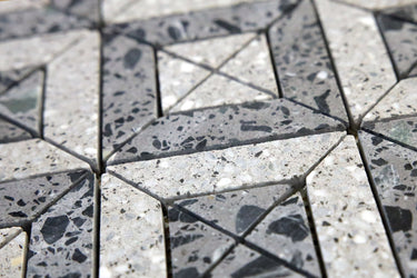 Close-up of grey terrazzo tile showing aggregate texture and pattern